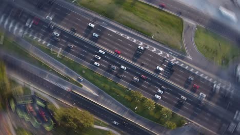 toma aérea en círculo que muestra muchos vehículos en la carretera en la ciudad de buenos aires durante la puesta de sol - de arriba hacia abajo