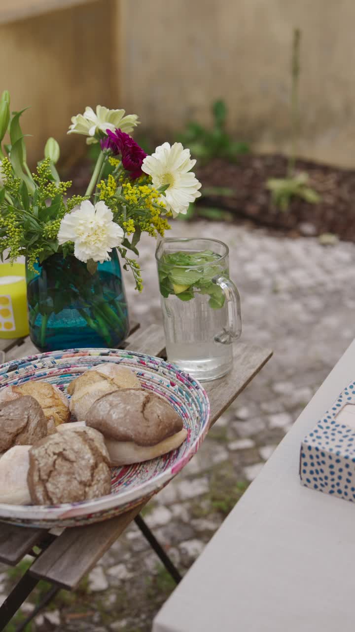 Outdoor garden dining with flowers and bread
