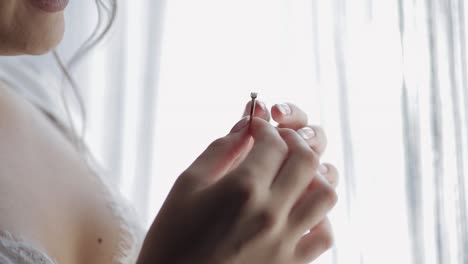 close up of woman's hand holding engagement ring