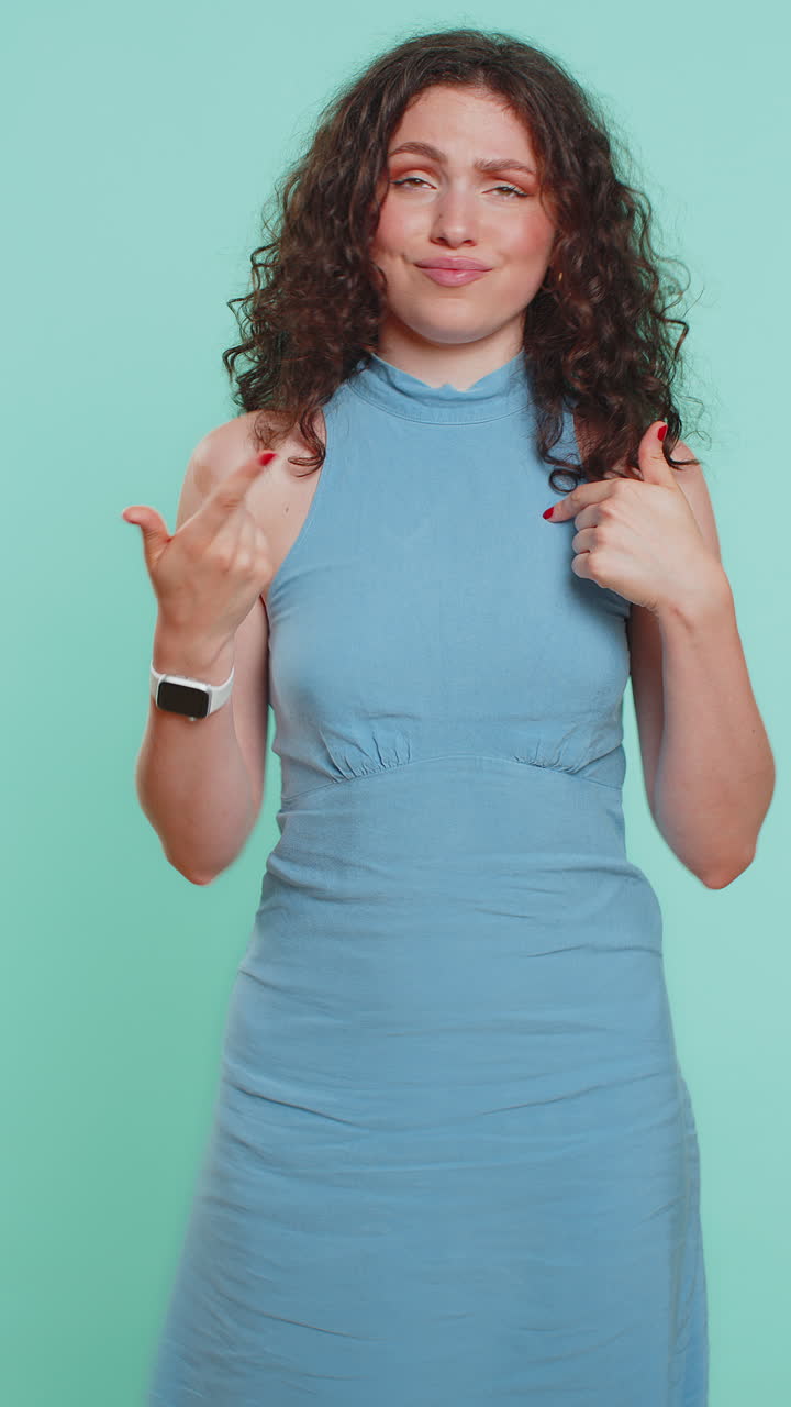 Young woman feeling very proud pointing herself overjoyed by success making choice selfconfident