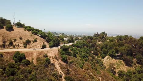 drone view of sherman oaks in the san fernando valley with mountains and luxurious homes in the background