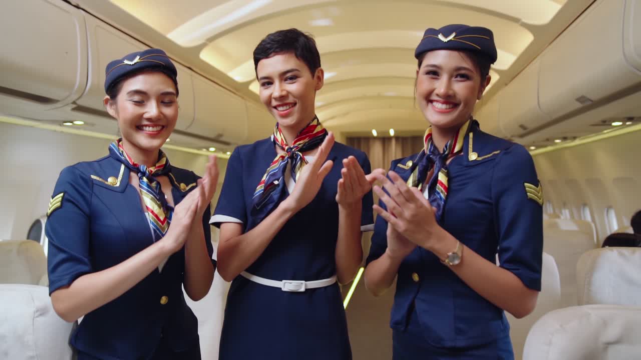 Premium stock video - Cabin crew clapping hands in airplane