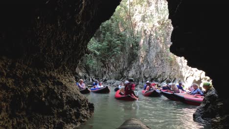 group kayaking in a scenic cave river