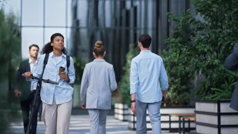 happy businesswoman walking drink coffee. manager use rental vehicle at office.