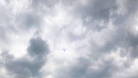 dramatic grey cloudscape covering the sky. stormy clouds accumulation from low angle view. timelapse.