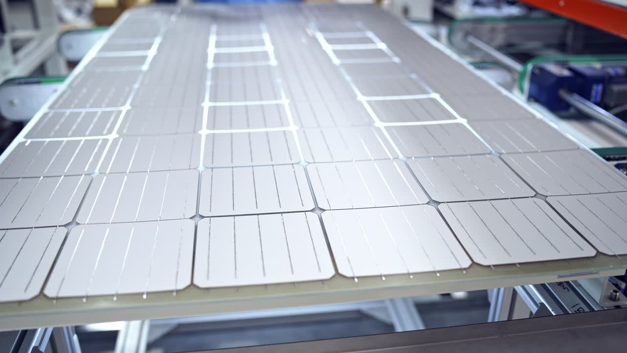 Automated factory equipment of energy device at work. Special machine makes new solar panels.