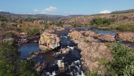 mountain range with water flow in rocky river