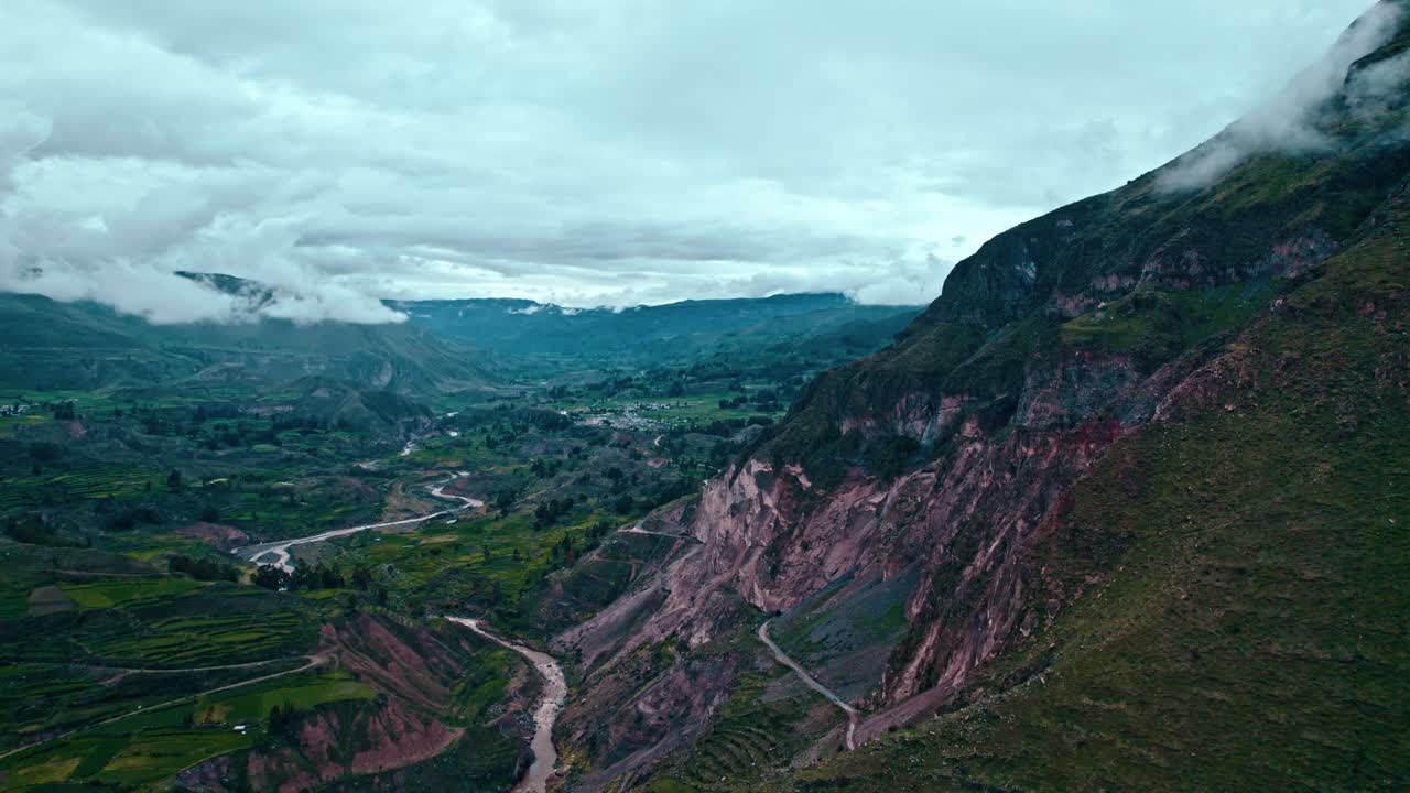 Drone flight over Colca Valley, Pe&ntilde;ablanca mountain to the right, cloudy day after rain, views of Maca village, and Colca Rive