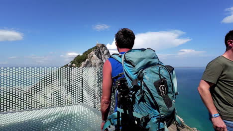 backpacker at cable car top station touristic attraction in gibraltar