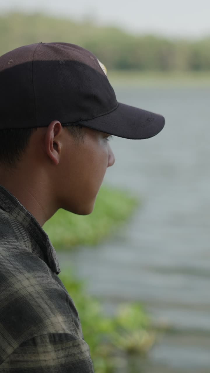 Man with cap by the lake