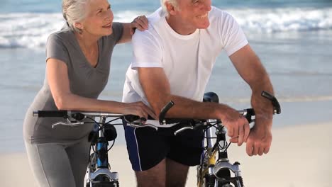 Älteres-Paar-Mit-Fahrrädern-Und-Blick-Auf-Den-Strand