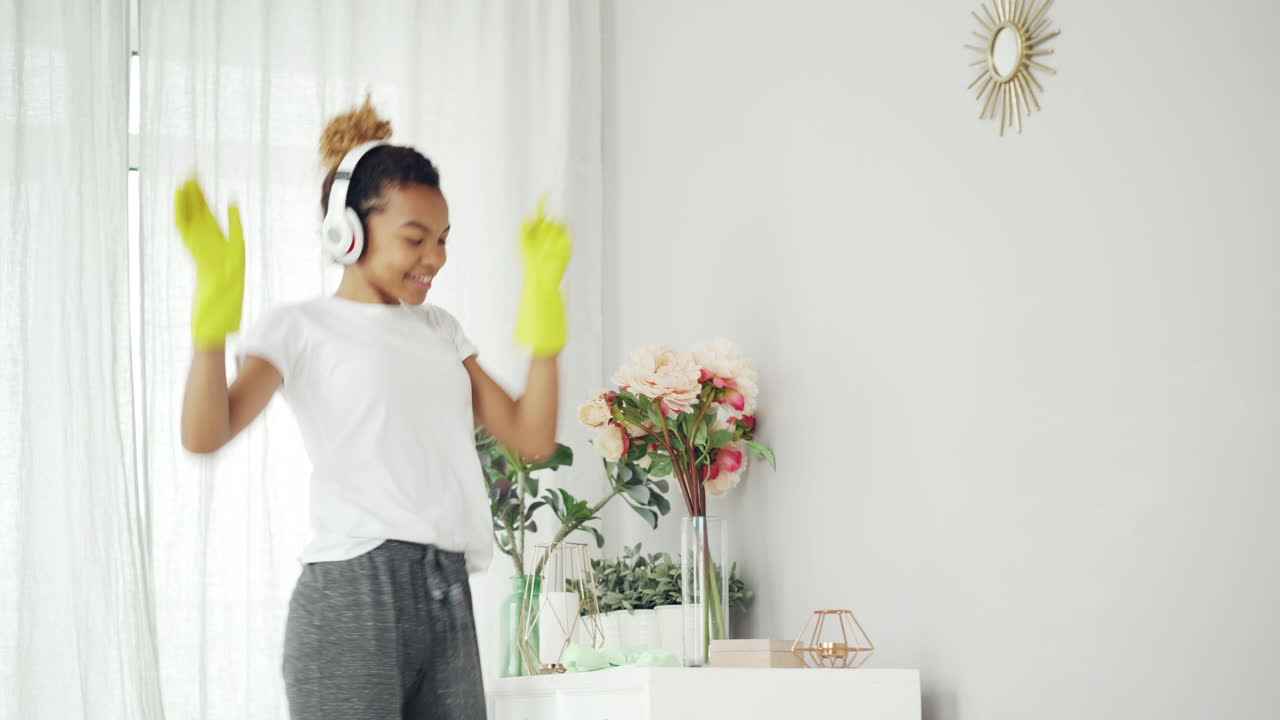 Woman Cleaning a Room with Headphones On