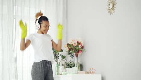 woman cleaning a room with headphones on