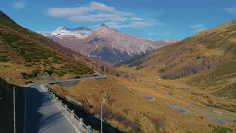 Aerial-view-across-scenic-alpine-mountain-countryside-serpentine-Splügen-pass-road-in-Switzerland