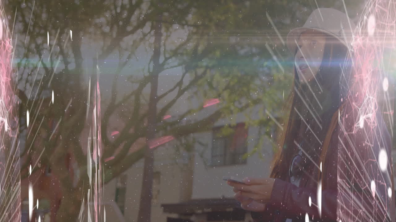 Woman walking outdoors holding smartphone displaying glitch effect and network lines for technology