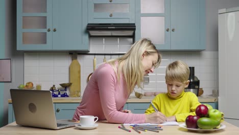 mother and son doing homework in the kitchen