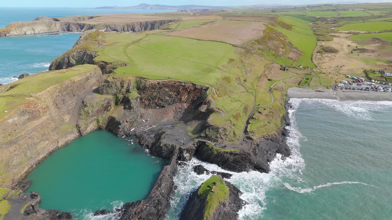 Aerial View Of Blue Lagoon On Sheer Coastal Cliffs In Pembrokeshire, Wales, United Kingdom. downward, wide shot