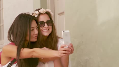 smiling hipster friends taking selfie together