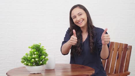 indian girl showing thumbs up