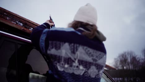 the man is securing the wooden planks onto the roof of his vehicle in indre fosen, trondelag county, norway - close up