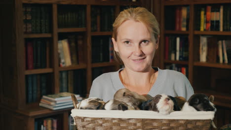 portrait of a woman with a basket full of little puppies