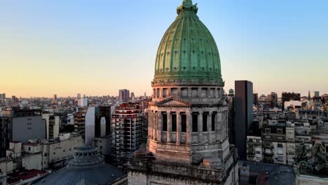 dome of argentina's national congress' at sunset, aerial view, orbit