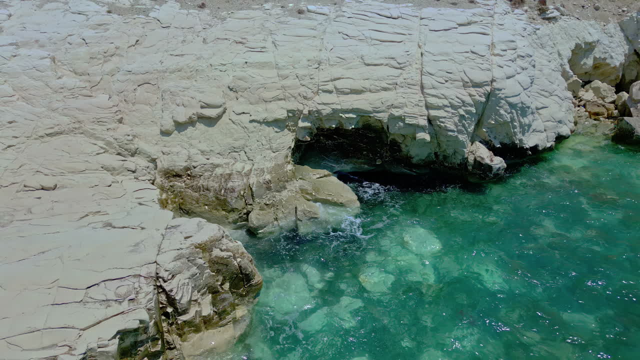 White Rocks, Cyprus, Sunny Beautiful Day, Small Waves Gently Lapping Rocks, Aerial Shot Flying Backwards, Zooming Out