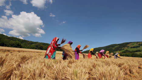 women harvesting wheat in a field