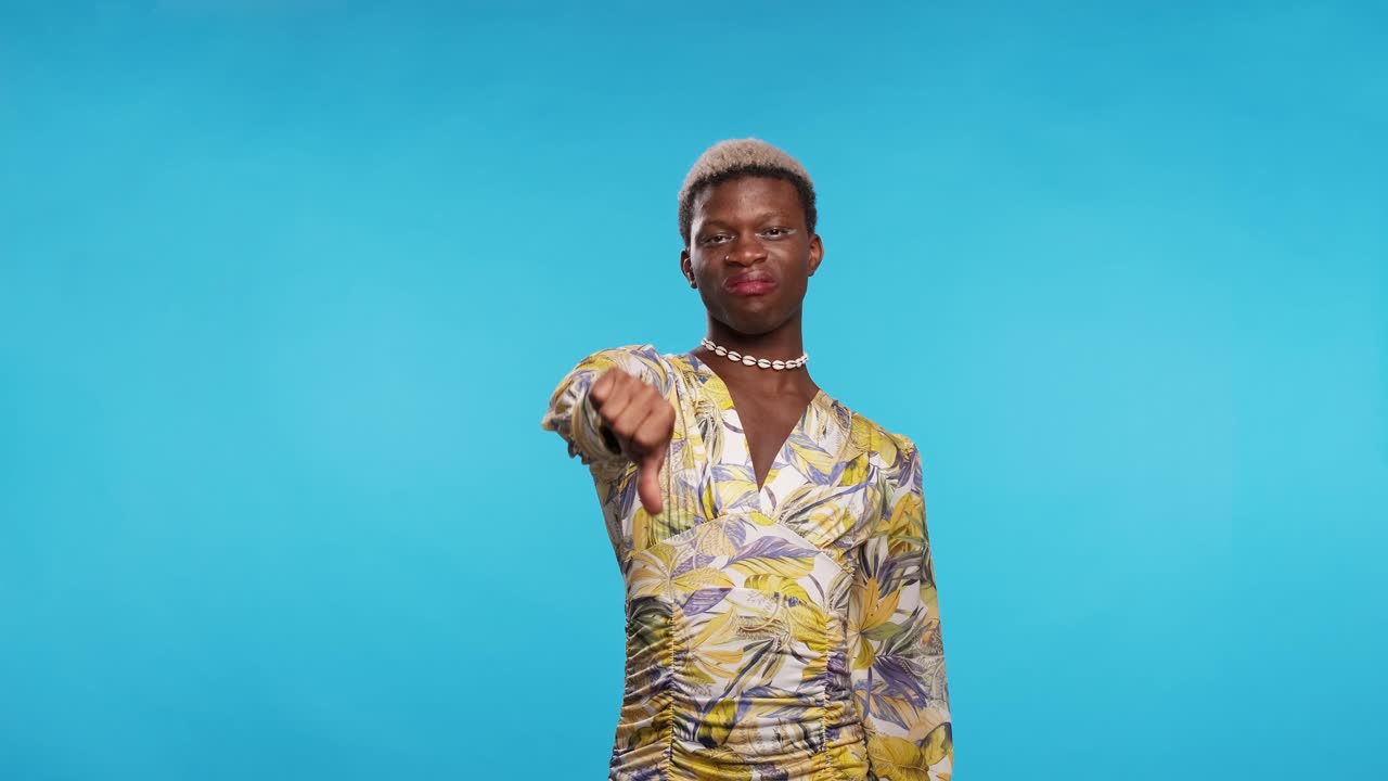 Displeased black gay man gesturing thumb down