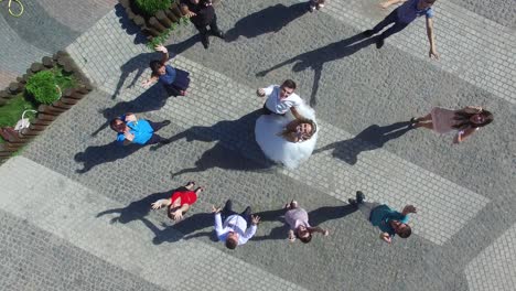 newlywed couple having fun outdoors. vinnitsa, ukraine - august 2016: aerial shot of a newlywed couple, bridesmaids and groomsmen having fun outdoors