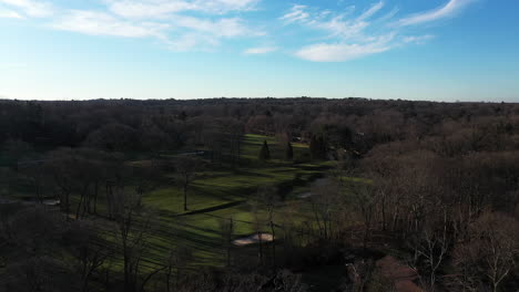 An-aerial-view-just-above-brown,-bare-treetops