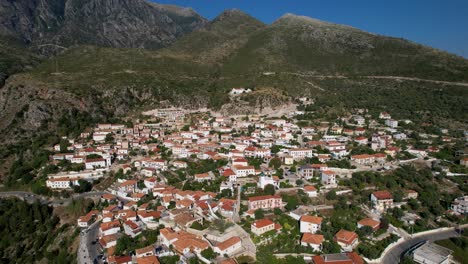 Mediterranean-village-of-Dhermi-in-Albania,-white-houses,-red-roofs,-cobblestone-alleys-on-slope-of-mountains-overlooking-Ionian-sea