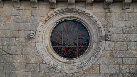 drone shot of church with saint sculpture and rounded stained glass window