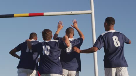 rugby players celebrating on the field