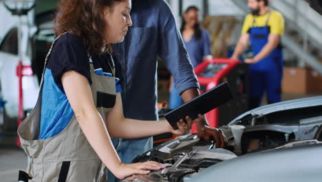 worker informs man of car repair costs