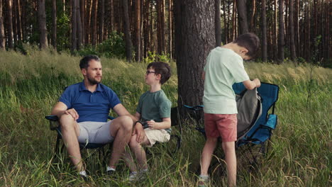 Family-camping-and-sitting-on-chairs