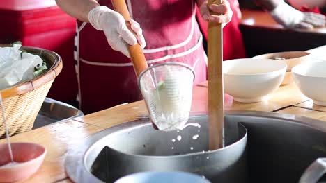 pouring and stretching dough to make noodles