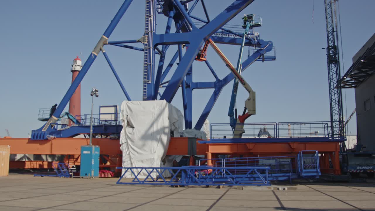 Beautiful tilt down of a pre-piling template being constructed at a dock in a harbor. The piling template will be used to place offshore wind turbines in deep water