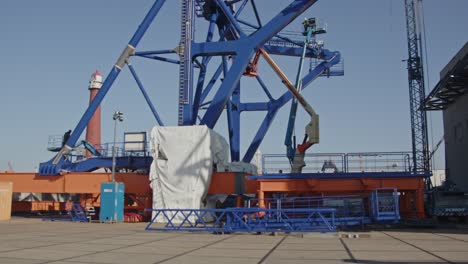 beautiful tilt down of a pre-piling template being constructed at a dock in a harbor. the piling template will be used to place offshore wind turbines in deep water