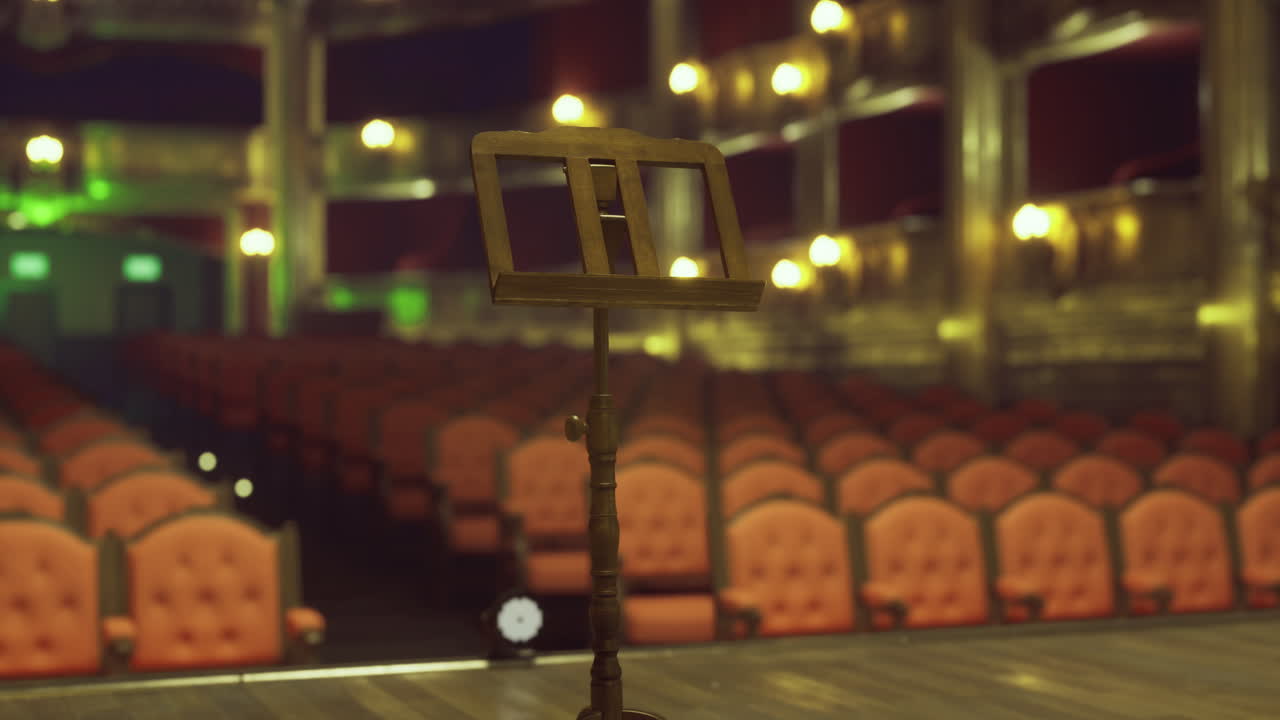 Empty theater stage with a music stand awaiting a performance in the evening