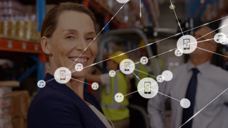 Animation-of-network-of-connections-with-icons-over-diverse-business-people-working-in-warehouse