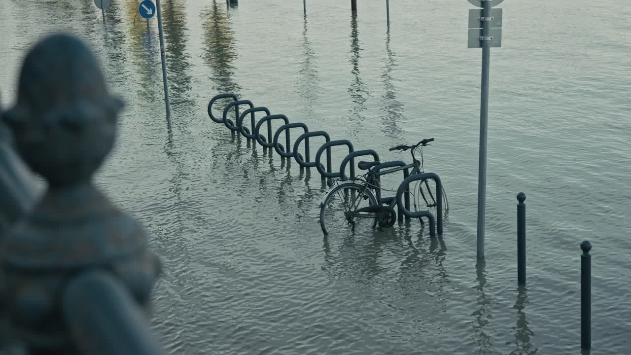 bicycle partially submerged in floodwater at a bike rack during the Budapest Flood 2024