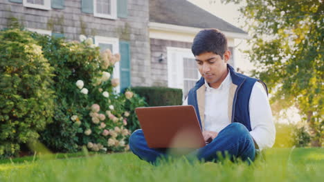 Man-Uses-Laptop-in-Backyard