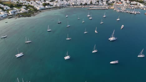 Aerial-footage-of-the-town-and-port-of-Parikia-on-the-island-of-Paros,-one-of-the-many-Cyclades-Islands-in-the-Aegean-Sea