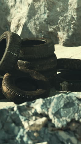 pile of old tires near rocks