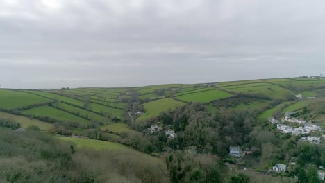 aerial tracking from right to left of a wintery but clear english countryside fielded area