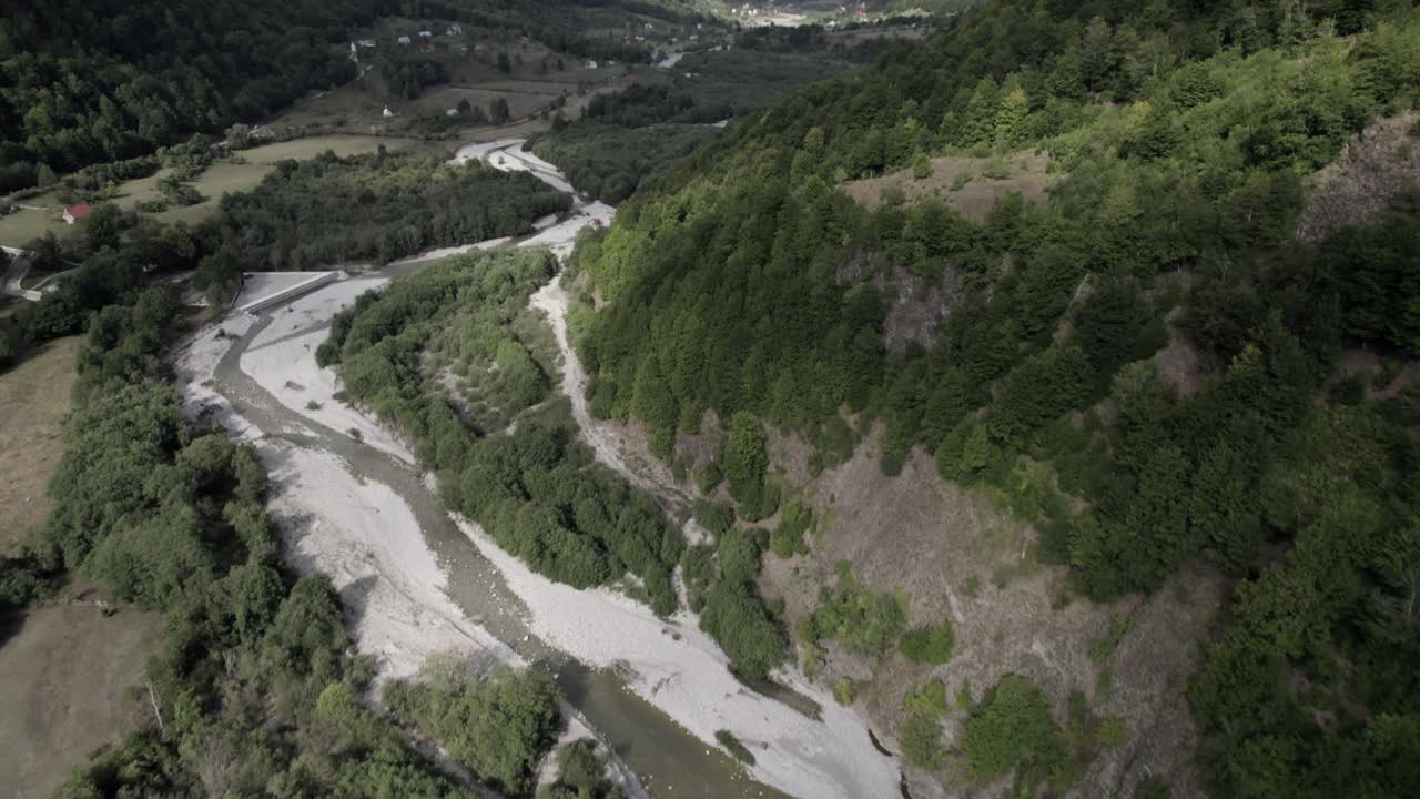 video descriptivo de un dron panorámico que avanza sobre el valle vermosh sobre el río vermoshi, el sh20 a la altura de bashkimi, albania