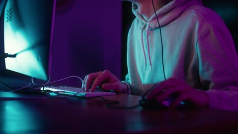 unrecognizable caucasian man playing game at night among neon lightning