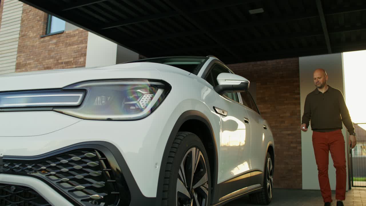 hombre entrando en un suv blanco en el garaje
