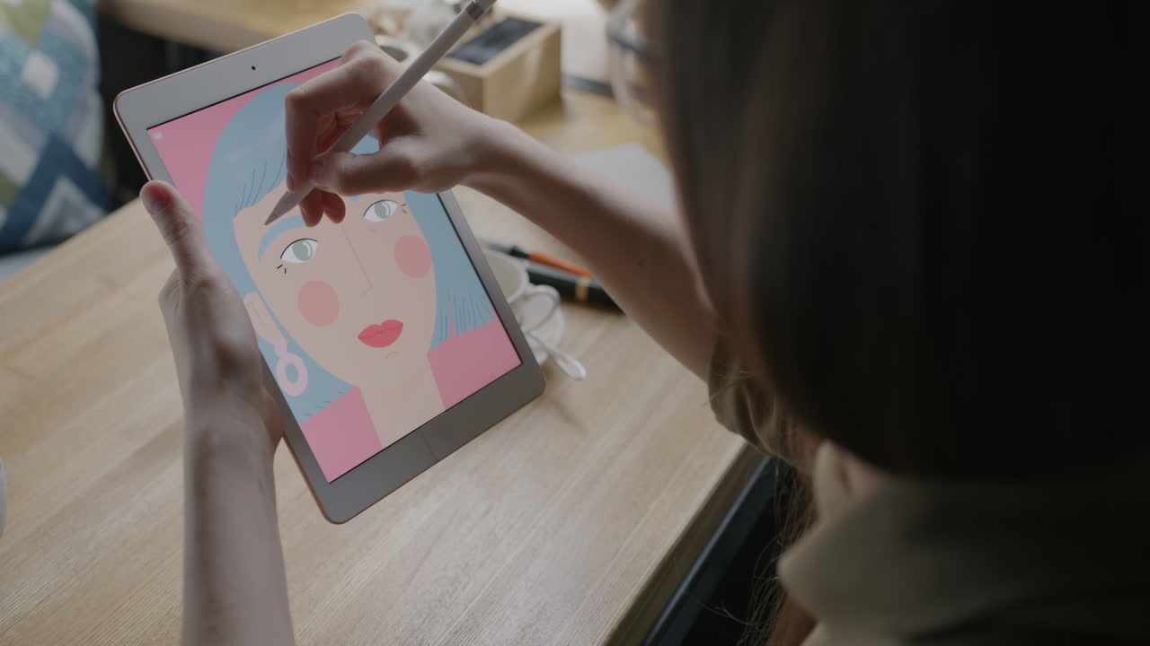 Woman Drawing on Tablet in Cafe